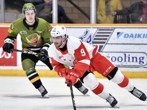 Soo Greyhounds defenceman Rob Calisti (right) streaks away from a Battalion defender in OHL action in North Bay.