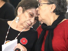 Shirley Roach is comforted by Barbara Nolan after speaking at ceremony marking signing of addendum to a covenant with Algoma University, Shingwauk Education Trust and Shingwauk Kinoomaage Gamig at Arthur A. Wishart Library at Algoma University in November 2018.  BRIAN KELLY