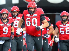 Shane Bergman of the Calgary Stampeders runs onto the field during player introductions before facing the Toronto Argonauts in CFL football in July 2019.