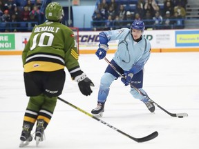 Nathan Ribau, right, of the Sudbury Wolves, attempts to fire the puck past Chad Denault, of the North Bay Battalion, during OHL action at the Sudbury Community Arena in Sudbury, Ont. on Friday January 10, 2020.