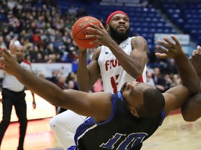 Dexter Williams Jr., of the Sudbury Five, drives to the basket against Akeem Scott, of the KW Titans, during basketball action at the Sudbury Community Arena in Sudbury, Ont. on Friday January 17, 2020.