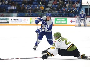 Liam Ross, left, of the Sudbury Wolves, attempts to fire the puck past Alex Christopoulos, of the North Bay Battalion, during OHL action at the Sudbury Community Arena in Sudbury, Ont. on Friday January 24, 2020. John Lappa/Sudbury Star/Postmedia Network