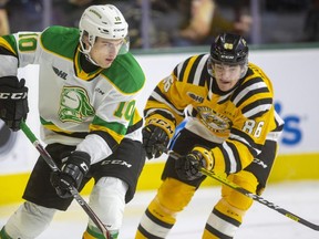 Stuart Rolofs of the London Knights keeps the puck in the Sarnia zone while being chased by Nolan Burke of the Sting during their New Year's Eve game Tuesday, Dec. 31, 2019, at Budweiser Gardens in London. Mike Hensen/The London Free Press/Postmedia Network