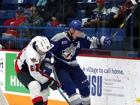 Sudbury Wolves defenceman Emmett Serensits (27) looks to hold off Windsor Spitfires forward Luke Boka (61) during first-period OHL action at Sudbury Community Arena in Sudbury, Ontario on Saturday, January 4, 2020.