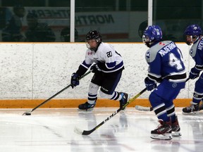 Kohyn Eshkawkogan (20) of the Nickel City Junior Sons handles the puck while Domenico Malafarina (44) and Kaden Wicklander (7) of the Sudbury Wolves defend during Northern Ontario Hockey League peewee AAA action at Gerry McCrory Countryside Sports Complex in Sudbury, Ontario on Saturday, February 8, 2020.