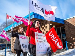 Kerrie Mealey (Front) leads a march of protesters bearing union standards in front of the Grande Prairie Legion branch, where Alberta Premier Jason Kenney meets with the UCP Caucus, Monday, Feb 10, 2020. A second protest involving the CUPE, AUPE, UNA and local students occurred outside Revolution Place later that evening, where the premier and caucus were also gathered.