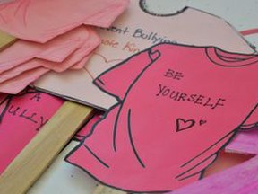 Photos of encouraging messages written on Pink t-shirts to celebrate Pink Shirt Day at a school in Fort Saskatchewan, Alta.