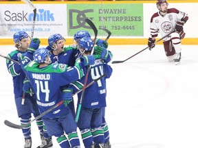 Melfort Mustangs' players celebrate after Alex Rondeau's first period goal during the Mustangs' 3-2 win over the Flin Flon Bombers on Wednesday, February 12 at the Northern Lights Palace.