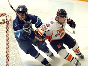 Josh Pope-Ferguson, right, of the Essex 73's tangles with Wheatley Sharks' Braydon Davis in Game 1 of their Provincial Junior Hockey League playoff series in Essex, Ont., on Tuesday, Feb. 11, 2020.   (NICK BRANCACCIO/Windsor Star)