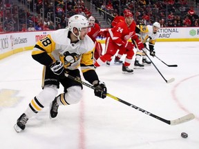 Pittsburgh Penguins' Alex Galchenyuk looks for an open teammate in front of Detroit Red Wings' Madison Bowey during the first period at Little Caesars Arena in Detroit, Mich., on Jan. 17, 2020. Gregory Shamus/Getty Images