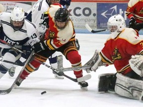 Woodstock Navy Vets forward Kurtis Christo tries to get a shot on Paris Mounties goalie Justin Hergott at Southwood Arena.