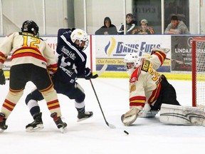 Goalie Justin Hergott of the Paris Mounties reaches to make a save on Woodstock Navy Vets player Reid Campbell while Paris player Wil Hurley tries to tie him up. Woodstock defeated Paris 3-2 on Saturday in Provincial Junior Hockey League playoff action, allowing the Navy Vets to advance.