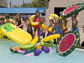Children toss fruit-shaped inflatable pool toys into the Lazy River at Earl Haig Park as part of the Healthy Kids Water Does Wonders event in 2016. Expositor file photo
