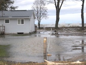 Waves from Lake St. Clair crash over a break wall in Lighthouse Cove. (File photo)