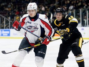 Sarnia Sting's Peter Stratis (42) checks Windsor Spitfires' Kyle McDonald (25) in the second period at Progressive Auto Sales Arena in Sarnia, Ont., on Friday, Feb. 7, 2020. Mark Malone/Chatham Daily News/Postmedia Network