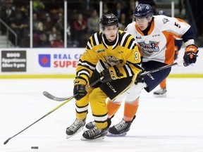 Sarnia Sting's Ryan Mast (3) protects the puck from Flint Firebirds' Emmet Pierce (5) in the second period at Progressive Auto Sales Arena in Sarnia, Ont., on Monday, Feb. 17, 2020. Mark Malone/Chatham Daily News/Postmedia Network