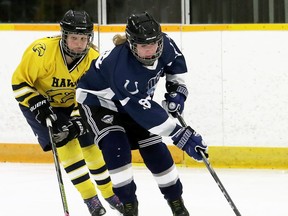 Ursuline Lancers' Brooke MacLeod, right, is chased by Chatham-Kent Golden Hawks' Abby Tape in the first period of the LKSSAA 'AAA' girls' hockey final at Erickson Arena in Chatham, Ont., on Wednesday, Feb. 26, 2020. Mark Malone/Chatham Daily News/Postmedia Network