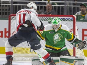 Egor Afanasyev of the Windsor Spitfires tries to get to a rebound in front of London Knights goaltender Brett Brochu at Budweiser Gardens in London, Ont., on Friday January 31, 2020.  Mike Hensen/The London Free Press/Postmedia Network