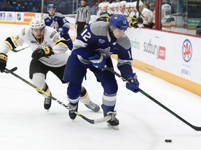 Matej Pekar, right, of the Sudbury Wolves, attempts to elude Theo Hill, of the Sarnia Sting, during OHL action at the Sudbury Community Arena in Sudbury, Ont. on Friday February 14, 2020.