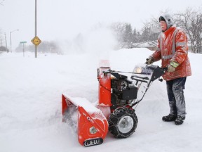 Doug Sarvas was covered in snow while using his snowblower to clear his driveway in Sudbury, Ont. on Tuesday February 18, 2020.