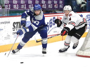 Liam Ross, left, of the Sudbury Wolves, eludes Isaac Enright, of the Niagara IceDogs, during OHL action at the Sudbury Community Arena in Sudbury, Ont. on Friday February 28, 2020. John Lappa/Sudbury Star/Postmedia Network