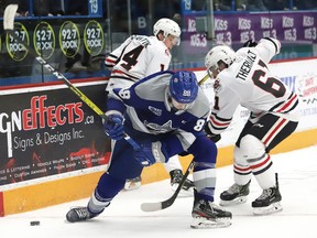 Kosta Manikis, left, of the Sudbury Wolves, and Lucas Theriault, of the Niagara IceDogs, battle for the puck during OHL action at the Sudbury Community Arena in Sudbury, Ont. on Friday February 28, 2020. John Lappa/Sudbury Star/Postmedia Network