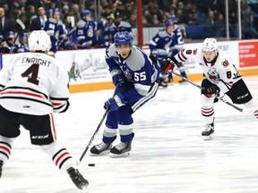 Quinton Byfield, middle, of the Sudbury Wolves, breaks between Isaac Enright, left, and Jackson Doherty, of the Niagara IceDogs, during OHL action at the Sudbury Community Arena in Sudbury, Ont. on Friday February 28, 2020.