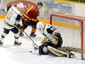 Kirkland Lake blue-liner Seth Coulter and Timmins Rock forward Riley Robitaille watch as a rebound bounces off the pad of Gold Miners goalie Kyle McNair.
THOMAS PERRY/THE DAILY PRESS/POSTMEDIA NETWORK