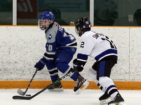 Jameson Fabbro (10) of the Sudbury Wolves handles the puck while Jordan Sampson-Jones (12) of the Nickel City Junior Sons defends during Northern Ontario Hockey League peewee AAA action at Gerry McCrory Countryside Sports Complex in Sudbury, Ontario on Saturday, February 8, 2020.