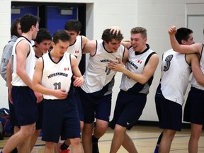 Jake French rubs the head of Cole Wadell as the St. Mary's Mustangs celebrate after beating the Georgian Bay Thunder in overtime to win the Bluewater Athletic Association senior boys basketball championship in Walkerton on Feb.20, 2020. Greg Cowan/The Sun Times