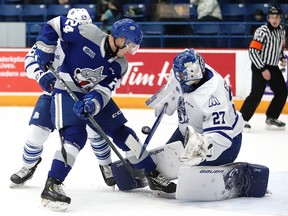 Sudbury Wolves Brad Chenier battles for the loose puck in front of  Mississauga Steelheads. goalie Kai Edmonds during OHL action from the Sudbury Community Arena on Sunday afternoon. Steelheads won 4-3 in a shootout.