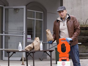 Dave Bissett, a board member at the Blessing Centre on Burnley Street in Brantford, holds a bagged meal that the centre is distributing to those in need.