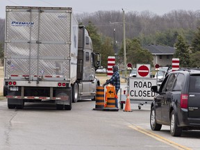 A transport truck is allowed to pass barriers on Highway 54 at Painter Road, as entry to Six Nations of the Grand River Territory had been restricted in an effort to prevent the spread of COVID19.  The barriers have now been taken down.