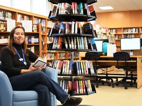 Amy Osborne, Chatham-Kent Public Library branch head for Ridgetown, holds a book at the Ridgetown Branch on March 13, 2020. The branch recently went through a $230,000 rejuvenation. (Tom Morrison/Postmedia Network)