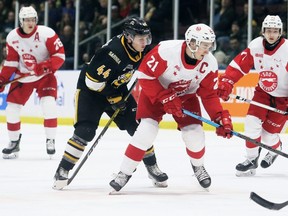Soo Greyhounds' Ryan O'Rourke (21) is  checked by Sarnia Sting's Jacob Perreault (44) in the second period at Progressive Auto Sales Arena in Sarnia, Ont., on Sunday, March 1, 2020. Mark Malone/Chatham Daily News/Postmedia Network