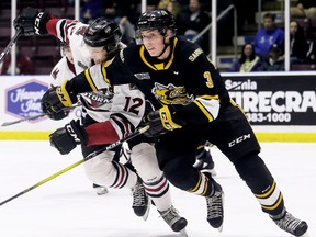 Sarnia Sting's Ryan Mast (3) battles Guelph Storm's Keegan Stevenson (12) in the second period at Progressive Auto Sales Arena in Sarnia, Ont., on Sunday, March 8, 2020. Mark Malone/Chatham Daily News/Postmedia Network
