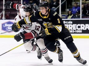 Sarnia Sting's Ryan Mast (3) battles Guelph Storm's Keegan Stevenson (12) in the second period at Progressive Auto Sales Arena in Sarnia, Ont., on Sunday, March 8, 2020. Mark Malone/Chatham Daily News/Postmedia Network