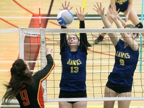 Chatham-Kent Golden Hawks' Maddison Allen (13) and Camille Blain (9) try for a block against London Saunders in a pool match at the OFSAA 'AAA' girls' volleyball championship at St. Clair College's Chatham Campus HealthPlex in Chatham, Ont., on Monday, March 9, 2020. Mark Malone/Chatham Daily News/Postmedia Network