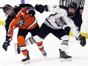 Wallaceburg Tartans' Ferrah Blackbird, right, and L'Essor Aigles' Meghan Parent collide during the second period of the SWOSSAA 'A-AA' girls hockey final at Wallaceburg Memorial Arena in Wallaceburg, Ont., on Monday, March 9, 2020. Mark Malone/Chatham Daily News/Postmedia Network