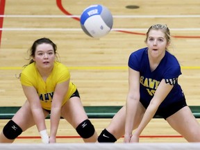 Chatham-Kent Golden Hawks' Macey Dziadura, right, receives a serve as Alexis Bruhlman watches against Peterborough St. Peter during a consolation quarter-final at the OFSAA 'AAA' girls' volleyball championship at St. Clair College's Chatham Campus HealthPlex in Chatham, Ont., on Tuesday, March 10, 2020. Mark Malone/Chatham Daily News/Postmedia Network