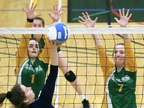 St. Patrick's Fighting Irish's Alyssa Gagne (1) and Emma Thompson (7) try for a block against the Orleans Beatrice-Desloges Bulldogs during the consolation final at the OFSAA girls' AAA volleyball championship at St. Clair College's Chatham Campus HealthPlex in Chatham, Ont., on Wednesday, March 11, 2020. Mark Malone/Chatham Daily News/Postmedia Network