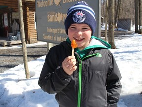 Emery Coleman, 11, nephew of Sand Road Maple Farm owner Scott Coleman, was enjoying a sweet treat during a visit from Russell. Photo on Sunday, March 15, 2020, in Moose Creek, Ont. (Todd Hambleton/Postmedia Network)