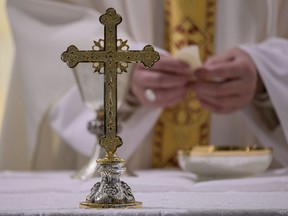 This photo taken and handout on March 19, 2020 by the Vatican Media shows a crucifix as Pope Francis breaks the consecrated host while celebrating a private morning mass at the Santa Marta chapel in the Vatican. (Photo by Handout / VATICAN MEDIA / AFP) / RESTRICTED TO EDITORIAL USE - MANDATORY CREDIT "AFP PHOTO / VATICAN MEDIA" - NO MARKETING - NO ADVERTISING CAMPAIGNS - DISTRIBUTED AS A SERVICE TO CLIENTS (Photo by HANDOUT/VATICAN MEDIA/AFP via Getty Images)

RESTRICTED TO EDITORIAL USE - MANDATORY CREDIT "AFP PHOTO / VATICAN MEDIA" - NO MARKETING - NO ADVERTISING CAMPAIGNS - DISTRIBUTED AS A SERVICE TO CLIENTS