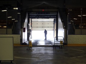 A City of Kingston worker walks by the ice resurfacer door at the Memorial Centre in March 2020 when it was being set up to be the Kingston area's second COVID-19 Assessment Centre.