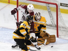 Kingston Frontenacs goaltender Christian Propp makes a save with Peterborough Petes' Michael Little and Frontenacs defenceman Lucas Peric in front of him during Ontario Hockey League action at the Leon's Centre on Feb. 5, 2020.