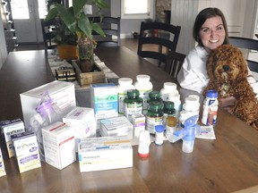 Melissa Snowden, and dog Trouper, of Egmondville, ON, displays all the medications she needs to ingest daily as she lives with Cystic Fibrosis. The 36-year-old is holding out hope that a new drug, Trikafta, will be available in Canada and allow her to stop taking so many other medications and dietary supplements. ANDY BADER