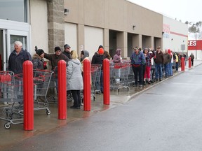 A line forms at the entrance to Costco earlier this year.