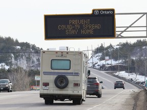 An overhead digital sign on Highway 69 South in Sudbury, Ont. on Wednesday March 25, 2020 is urging people to stay home to prevent the spread of COVID-19. John Lappa/Sudbury Star/Postmedia Network