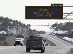 An overhead digital sign on Highway 69 South in Sudbury, Ont. on Wednesday March 25, 2020 is urging people to stay home to prevent the spread of COVID-19.