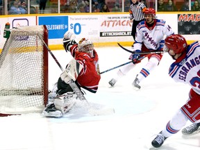 Attack goaltender Mack Guzda stretches out as Donovan Sebrango fires a shot over the net after getting a pass from teammate Serron Noel during a second-period rush. The Owen Sound Attack hosted the Kitchener Rangers inside the Harry Lumley Bayshore Community Centre Feb. 29, 2020. Greg Cowan/The Sun Times